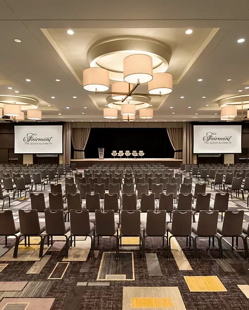 A ballroom at Fairmont The Queen Elizabeth set with rows of chairs facing a stage